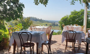 Table in the courtyard with countryside in the background at Bistro Molines
