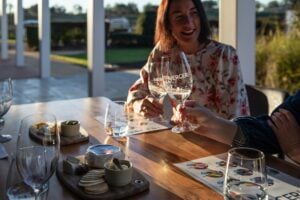 Two guests enjoying a wine tasting outside at Mercer Wines