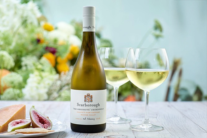 Scarborough Wine Bottle on a table with a plate of food